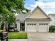 Charming home featuring a two-car garage and a well-manicured lawn with beautiful landscaping at 147 Wren Hill Dr, Mooresville, NC 28115