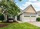 Charming home featuring a two-car garage and a well-manicured lawn with beautiful landscaping at 147 Wren Hill Dr, Mooresville, NC 28115
