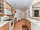 A kitchen with light wood cabinets, tile backsplash, and hardwood flooring, providing ample countertop space at 147 Wren Hill Dr, Mooresville, NC 28115