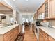 A well-lit kitchen featuring wooden cabinets, tile backsplash, and hardwood floors open to the dining area at 147 Wren Hill Dr, Mooresville, NC 28115