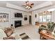 A cozy living room featuring a fireplace, built-in shelving, and access to another living space at 147 Wren Hill Dr, Mooresville, NC 28115