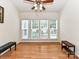 A bright living space illuminated by natural light with hardwood floors and modern ceiling fan fixture at 147 Wren Hill Dr, Mooresville, NC 28115