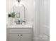 Elegant white powder room featuring a sleek black faucet, modern lighting, and neutral decor at 1490 White Hall Pl, Gastonia, NC 28056