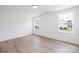 Light-filled bedroom with hardwood floors and views of the neighborhood through large, bright windows at 1490 White Hall Pl, Gastonia, NC 28056
