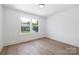Inviting bedroom showcasing bright windows with neighborhood views and minimalist design for relaxation at 1490 White Hall Pl, Gastonia, NC 28056