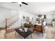 Open-concept living room showcasing hardwood floors, fireplace, and staircase, bathed in natural light at 1490 White Hall Pl, Gastonia, NC 28056