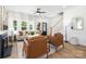Inviting living area with cozy seating, ample natural light, and a stylish staircase leading to the upper level at 1490 White Hall Pl, Gastonia, NC 28056