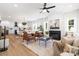 Bright, open-concept living space featuring a fireplace, leather armchairs, and seamless flow into the kitchen at 1490 White Hall Pl, Gastonia, NC 28056