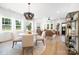 Spacious, sunlit living area with elegant furnishings, flowing seamlessly into the dining area and kitchen at 1490 White Hall Pl, Gastonia, NC 28056