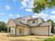 Rear exterior featuring the home's light siding, well maintained lawn, and covered patio at 1490 White Hall Pl, Gastonia, NC 28056