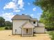 Rear exterior showcasing the home's siding, covered patio, and well maintained lawn at 1490 White Hall Pl, Gastonia, NC 28056