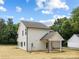 Rear exterior showing the home's well maintained lawn, siding, and covered patio at 1490 White Hall Pl, Gastonia, NC 28056
