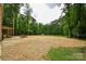 Open yard for a home with a picnic table and wooded area in the distance at 15025 Barbee Rd, Stanfield, NC 28163