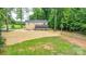 Spacious backyard featuring a screened porch, patio, and wooded surroundings at 15025 Barbee Rd, Stanfield, NC 28163