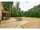 Outdoor patio with a grill, seating, and view of the expansive backyard at 15025 Barbee Rd, Stanfield, NC 28163