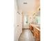 Bright bathroom featuring double sinks, and a shower/tub with glass door at 15025 Barbee Rd, Stanfield, NC 28163