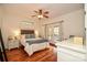 Comfortable bedroom featuring white furnishings, hardwood floors, and French doors at 15025 Barbee Rd, Stanfield, NC 28163