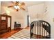 Cozy Bedroom with hardwood floors, a rocking chair, and a crib at 15025 Barbee Rd, Stanfield, NC 28163