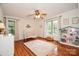 Bright Bedroom featuring hardwood floors, crib, large window, and ample space at 15025 Barbee Rd, Stanfield, NC 28163