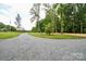 Long gravel driveway leading to the property at 15025 Barbee Rd, Stanfield, NC 28163