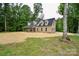 Side view of brick home with lawn at 15025 Barbee Rd, Stanfield, NC 28163
