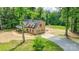 Aerial view of a two-story brick home with an attached garage and ample parking at 15025 Barbee Rd, Stanfield, NC 28163