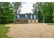 Charming brick home with a cozy front porch, nestled among mature trees at 15025 Barbee Rd, Stanfield, NC 28163