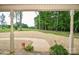 Charming covered front porch featuring a view of the meticulously landscaped yard and a pathway to the expansive lawn at 15025 Barbee Rd, Stanfield, NC 28163