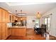 Well-lit kitchen featuring wood cabinets, stainless steel appliances, and adjacent dining area with natural light at 15025 Barbee Rd, Stanfield, NC 28163