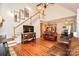 Open-concept living area with hardwood floors, stairs, and seamless transition to kitchen and dining, filled with natural light at 15025 Barbee Rd, Stanfield, NC 28163