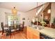 Open floor plan showcasing a kitchen, dining area, and living room with a cozy fireplace and hardwood floors at 15025 Barbee Rd, Stanfield, NC 28163
