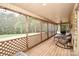 Spacious screened porch with views of the treed yard, plenty of seating, and an outdoor ceiling fan at 15025 Barbee Rd, Stanfield, NC 28163