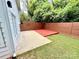 Backyard area featuring a small patio and a dark-stained privacy fence at 1519 Briar Creek Rd # B, Charlotte, NC 28205