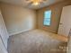 Comfortable carpeted bedroom offering plenty of natural light and a ceiling fan at 1519 Briar Creek Rd # B, Charlotte, NC 28205