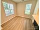 Bright bedroom with hardwood floors, large windows, and neutral walls creating a peaceful atmosphere at 1519 Briar Creek Rd # B, Charlotte, NC 28205