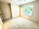 Bedroom featuring carpet flooring, a window, neutral paint, and a closet at 1519 Briar Creek Rd # B, Charlotte, NC 28205