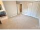 Inviting bedroom featuring neutral carpeting, a double door closet and ensuite bathroom entrance at 1519 Briar Creek Rd # B, Charlotte, NC 28205