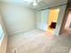 Bedroom featuring carpet flooring, a ceiling fan, and a sliding barn door with access to the bathroom at 1519 Briar Creek Rd # B, Charlotte, NC 28205