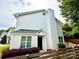 View of charming two-story home featuring low shrubs and proximity to nearby foliage and wooden fence at 1519 Briar Creek Rd # B, Charlotte, NC 28205