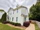 Charming two-story home features a well-manicured lawn, lush landscaping, and a welcoming pathway at 1519 Briar Creek Rd # B, Charlotte, NC 28205
