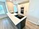 Modern kitchen with a stylish island, sleek stovetop, stainless steel appliances, and built-in cabinetry at 1519 Briar Creek Rd # B, Charlotte, NC 28205