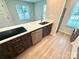 Kitchen island with sink, stainless steel appliances, and modern cabinets offering a bright and efficient space at 1519 Briar Creek Rd # B, Charlotte, NC 28205