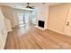 Inviting living room featuring light wood floors, a modern fireplace, and natural light from the doors and windows at 1519 Briar Creek Rd # B, Charlotte, NC 28205