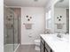 Clean bathroom with a glass-enclosed shower, a large mirror, and modern fixtures at 1607 Tundra Ln, Denver, NC 28037