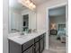 Double sink bathroom, vanity with cabinets, and mirror overlooking the bedroom at 1607 Tundra Ln, Denver, NC 28037