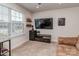Spare bedroom, featuring a comfortable couch, mini-fridge, and a mounted TV at 1607 Tundra Ln, Denver, NC 28037