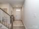 Bright entryway with a staircase, decorative rug, and stylish console table at 1607 Tundra Ln, Denver, NC 28037