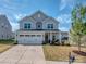 Charming two-story house with a spacious two-car garage, well-maintained lawn, and beautiful landscaping, great curb appeal at 1607 Tundra Ln, Denver, NC 28037