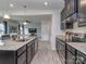 Modern kitchen featuring stainless steel appliances, granite countertops, and a seamless connection to the living area at 1607 Tundra Ln, Denver, NC 28037