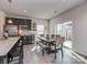 Bright eat-in kitchen boasts black cabinets, stainless appliances, granite counters and sliding glass door at 1607 Tundra Ln, Denver, NC 28037